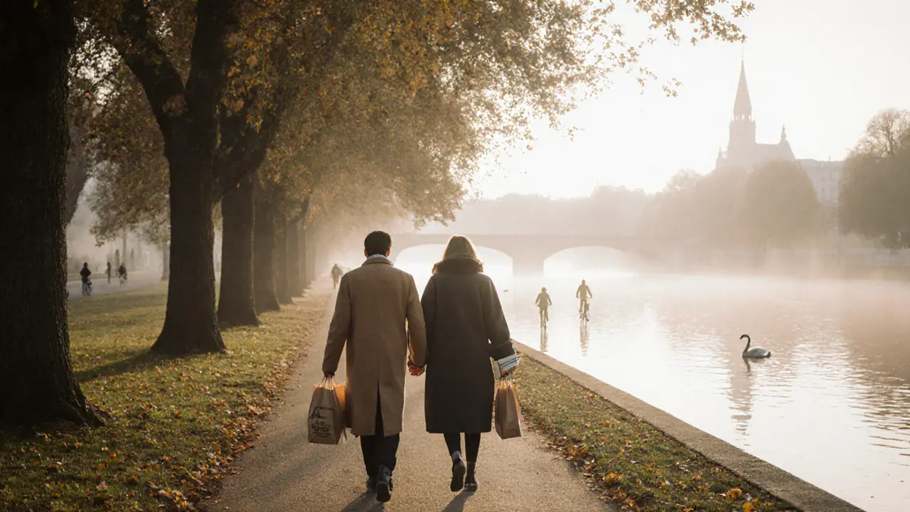 Two people walking peacefully through Englischer Garten at dawn, coats wrapped, book and bakery bag in hand.